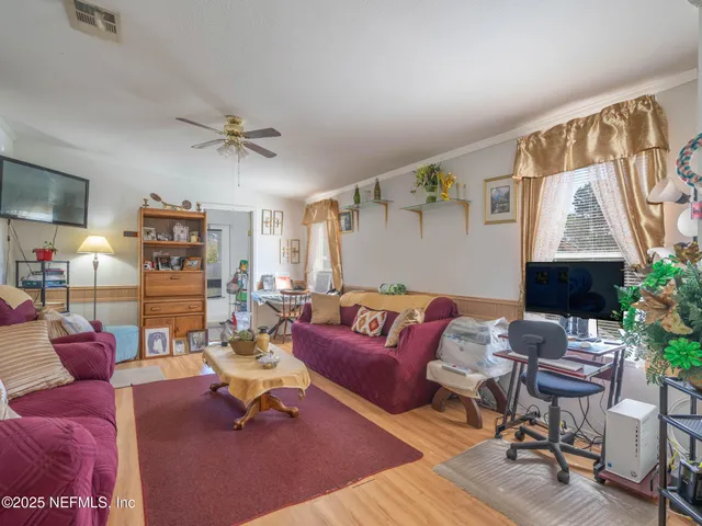 a living room with furniture and wooden floor