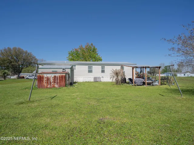a backyard of a house with table and chairs