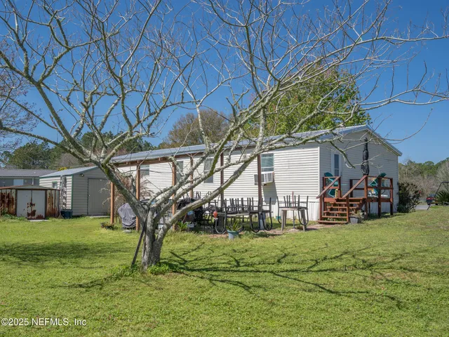 a view of a house with backyard and porch