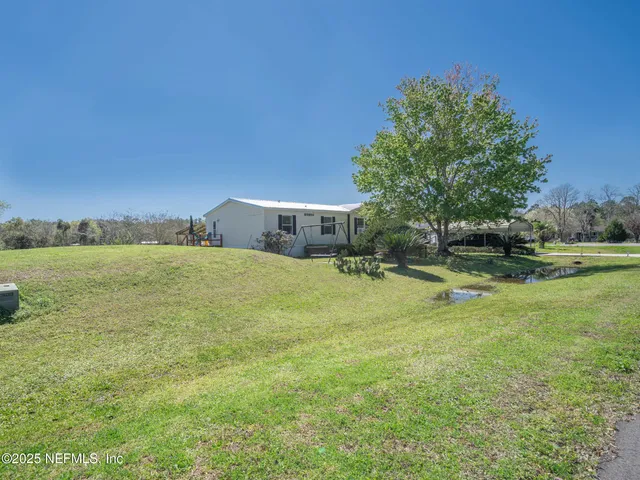 a view of yard with swimming pool and outdoor seating