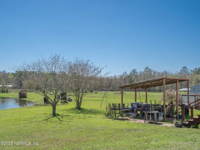 a view of lake with green field
