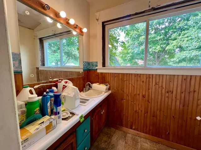 wooden floor in an empty room with a window