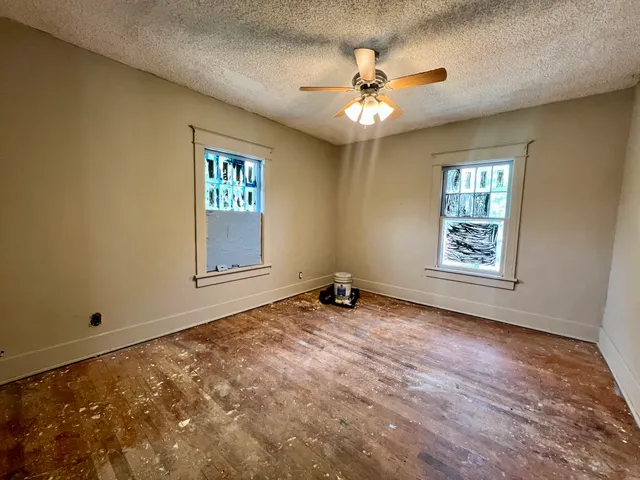 a view of a house with a yard covered in snow