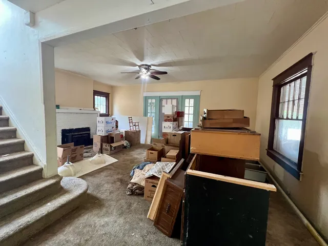 a living room with furniture fireplace and a window