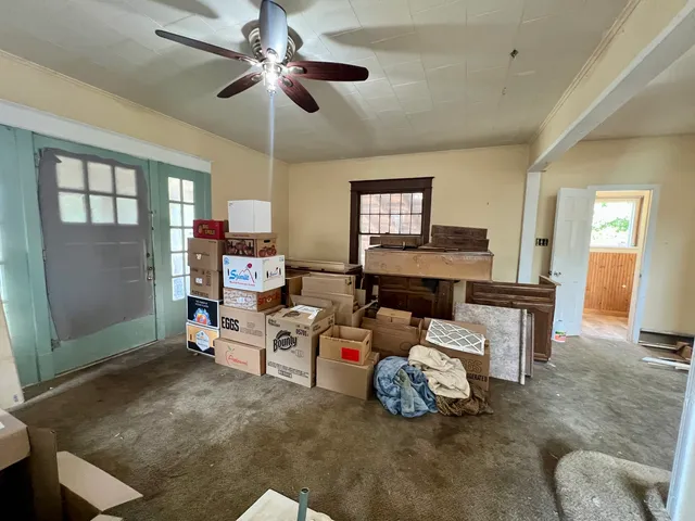 a bedroom with a bed and a large window