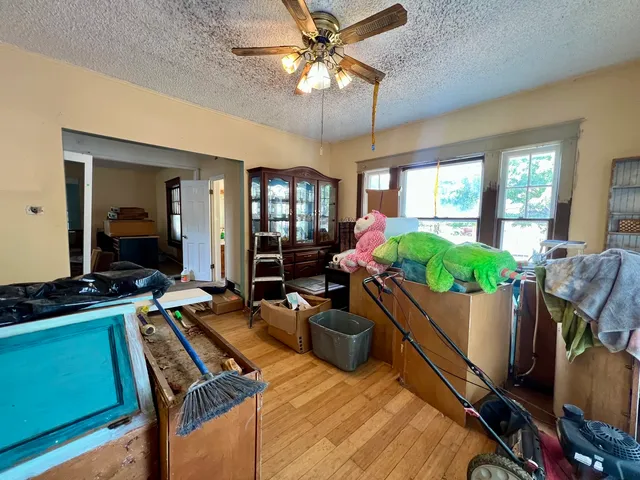 a bedroom with a bed and a mirror on the dresser
