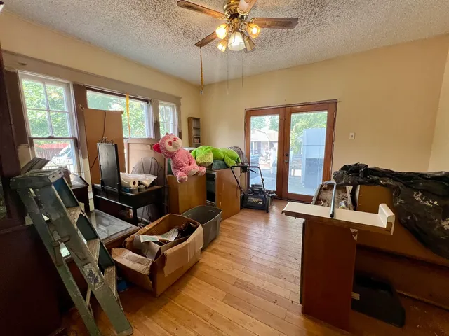 a view of a hallway with wooden floor and closet