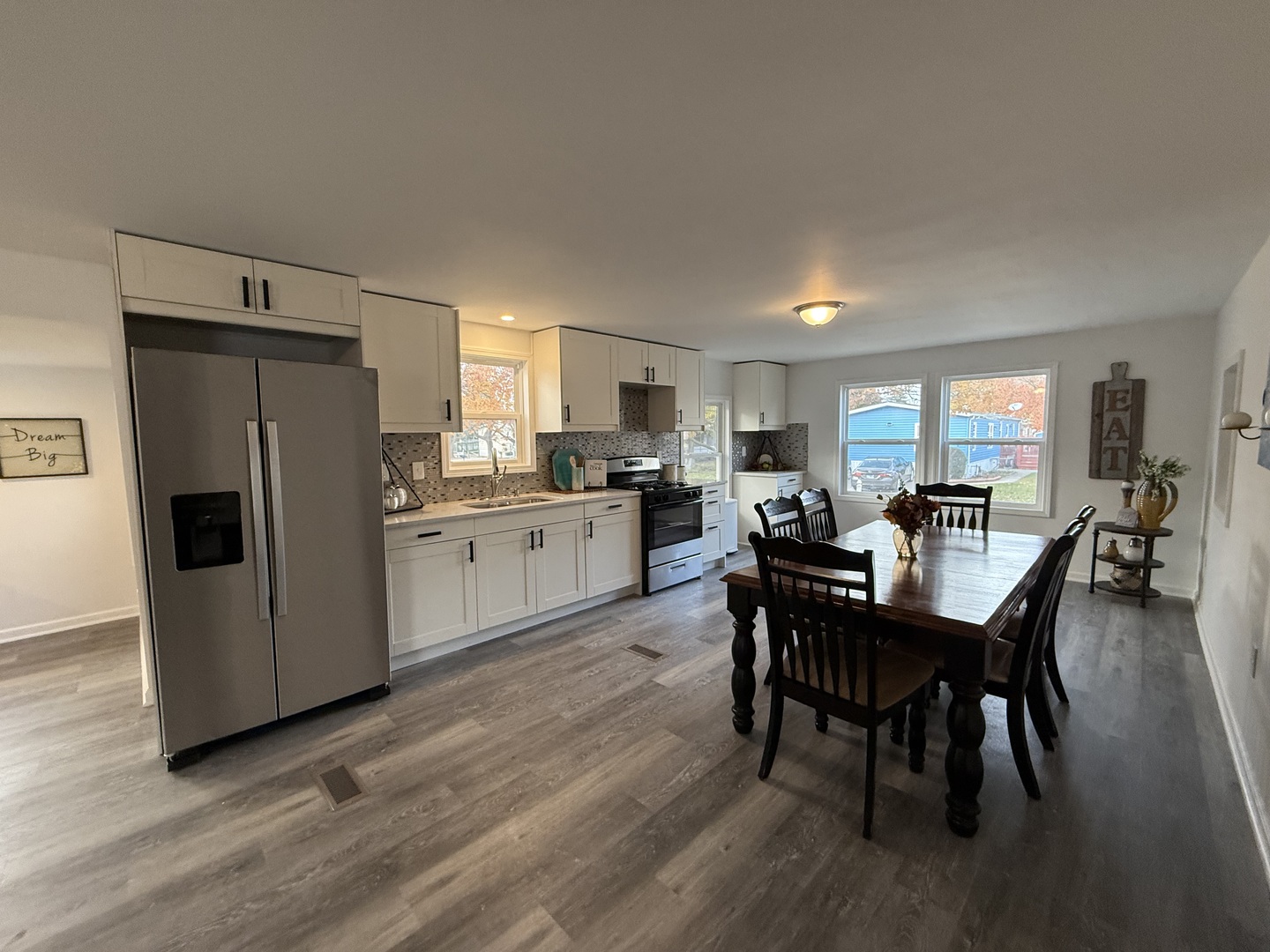 66 Candlegate Circle Matteson, IL 60443 - Photo 11 of 21 a kitchen with a dining table chairs refrigerator and cabinets