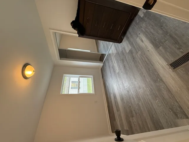 a view of a door and wooden floor
