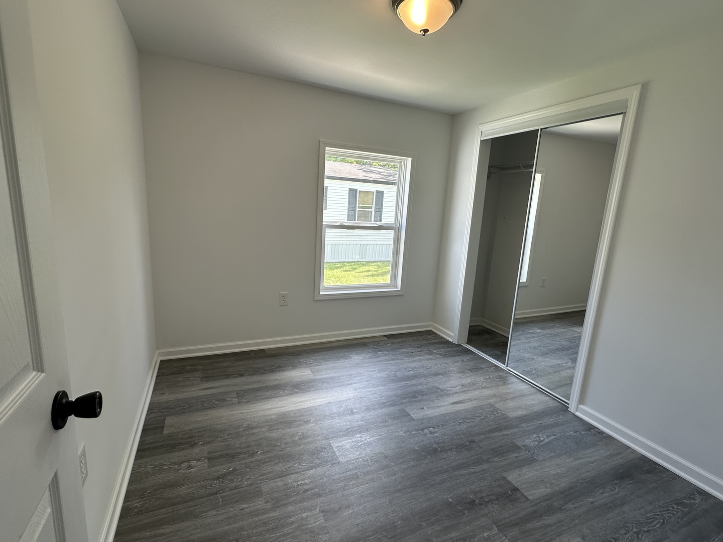 66 Candlegate Circle Matteson, IL 60443 - Photo 4 of 21 an empty room with wooden floor and windows