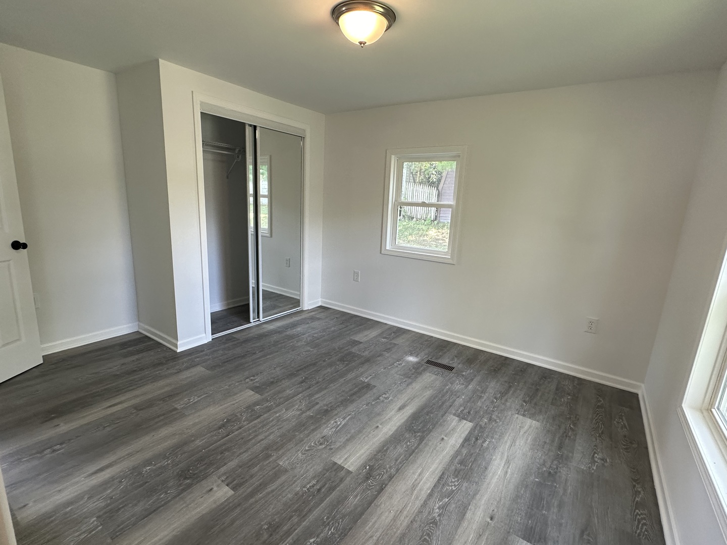 66 Candlegate Circle Matteson, IL 60443 - Photo 7 of 21 an empty room with wooden floor and windows
