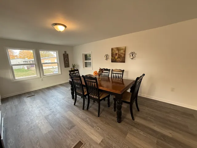 a view of a dining room with furniture and wooden floor