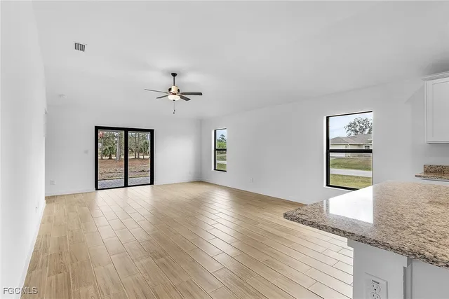 a view of a kitchen with granite countertop cabinets and wooden floor