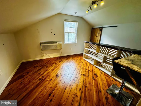a view of workspace room with wooden floor
