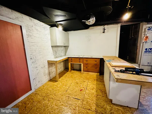 a view of backyard with wooden fence and large trees