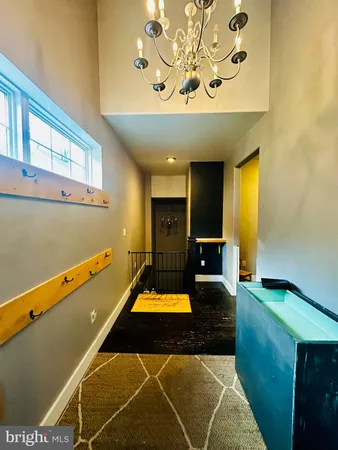 a room with pool table and a chandelier