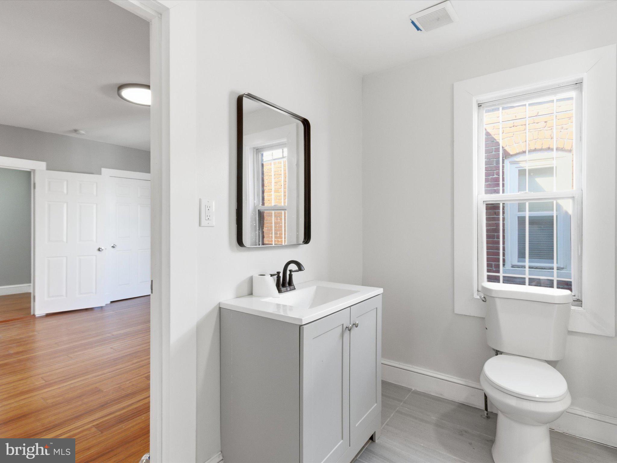 2617 13th Street Northwest, Unit PH Washington, DC 20009 - Photo 5 of 12 a bathroom with a toilet sink and mirror