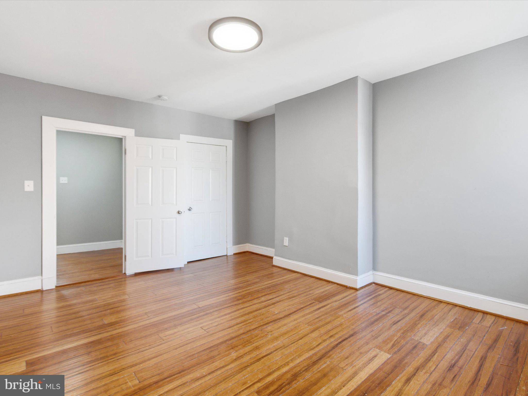 2617 13th Street Northwest, Unit PH Washington, DC 20009 - Photo 8 of 12 a view of an empty room with wooden floor