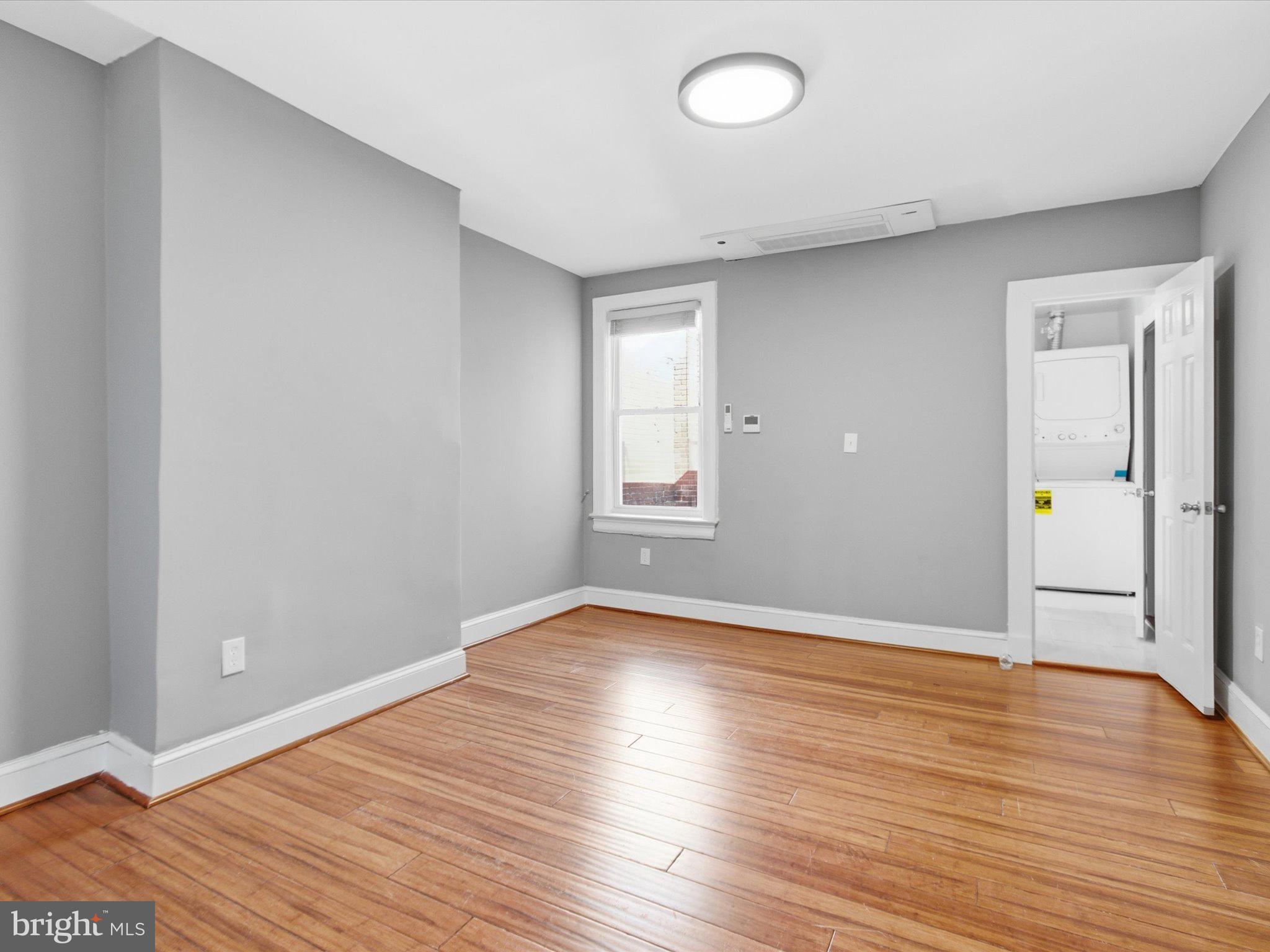 2617 13th Street Northwest, Unit PH Washington, DC 20009 - Photo 9 of 12 a view of an empty room with wooden floor and a window