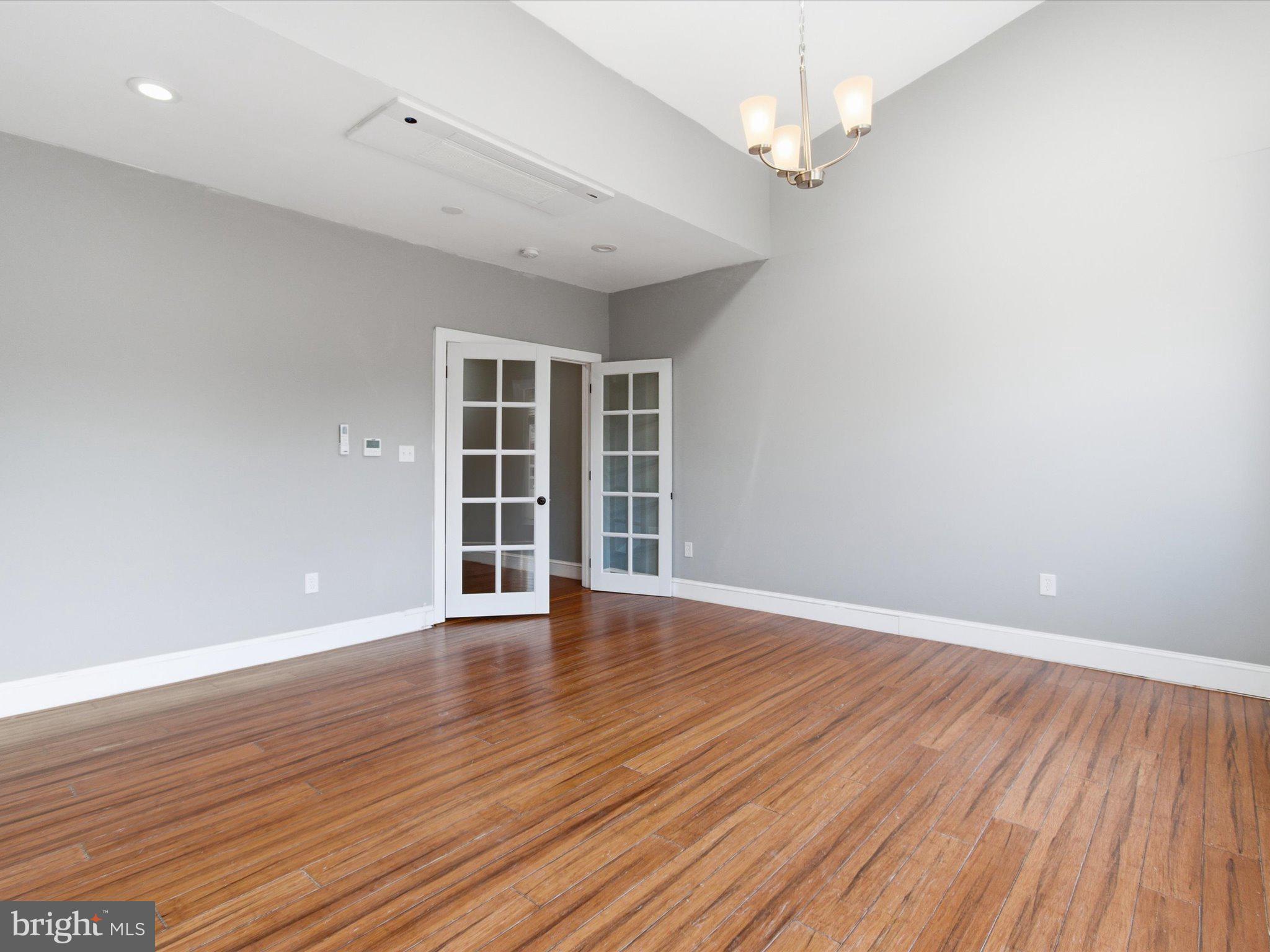 2617 13th Street Northwest, Unit PH Washington, DC 20009 - Photo 10 of 12 a view of an empty room with wooden floor ceiling fan