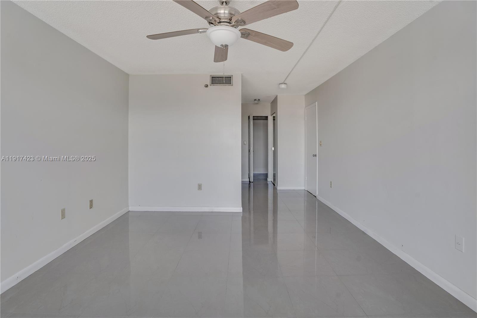 1200 St Charles Place, Unit 716 Pembroke Pines, FL 33026 - Photo 12 of 29 an empty room with a ceiling fan and window
