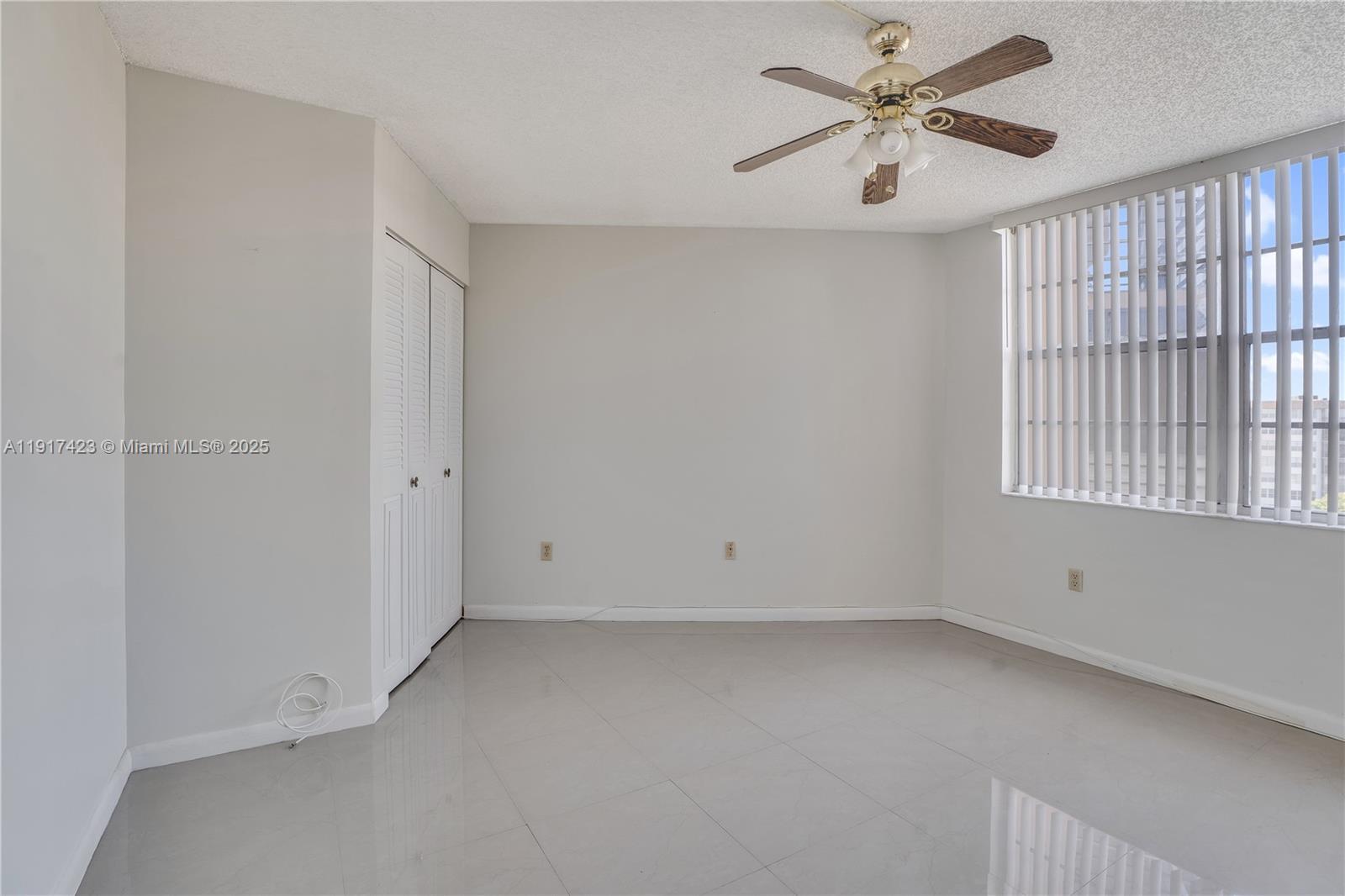 1200 St Charles Place, Unit 716 Pembroke Pines, FL 33026 - Photo 19 of 29 a view of room with a ceiling fan and window
