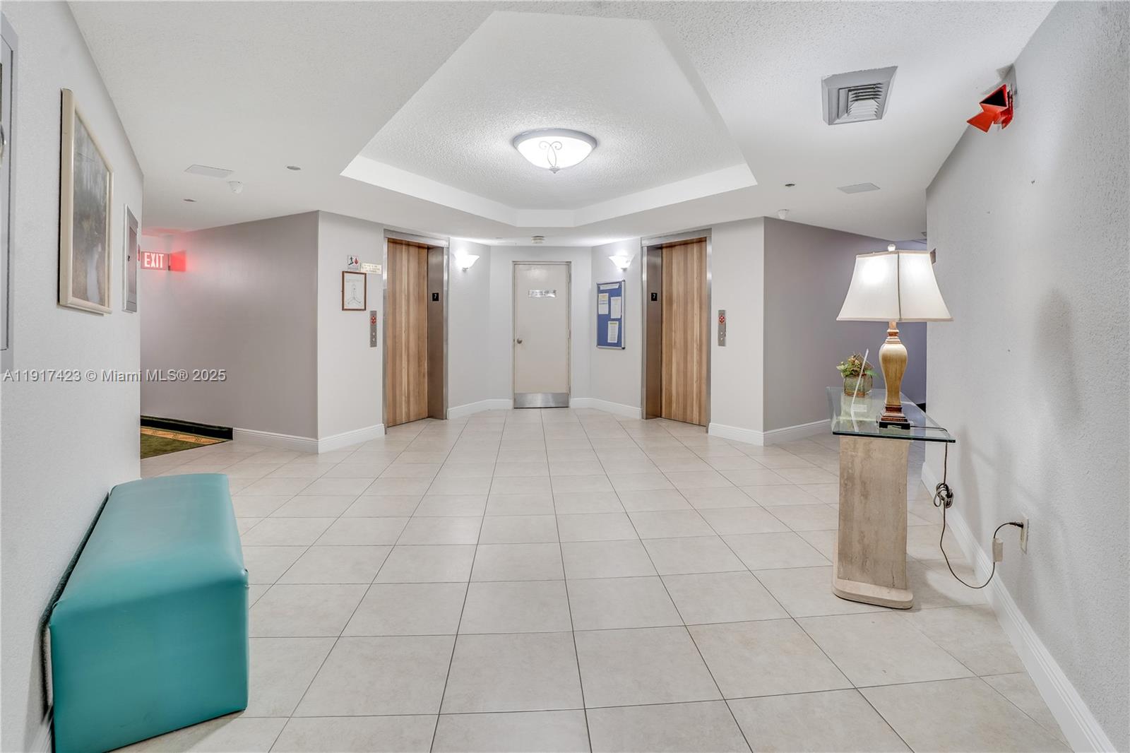 1200 St Charles Place, Unit 716 Pembroke Pines, FL 33026 - Photo 20 of 29 a view of a hallway with closet and a couch