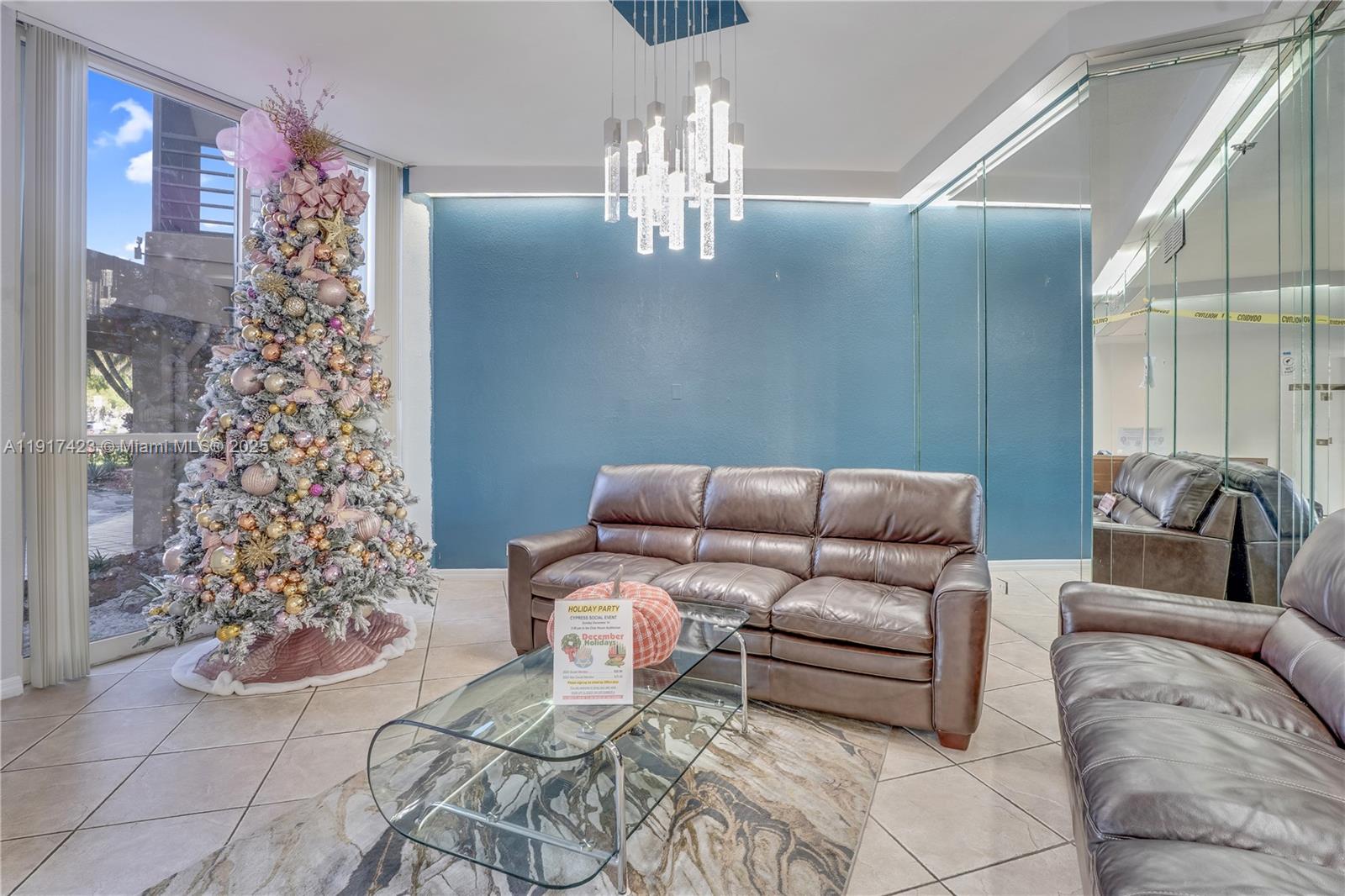 1200 St Charles Place, Unit 716 Pembroke Pines, FL 33026 - Photo 21 of 29 a living room with furniture and a chandelier