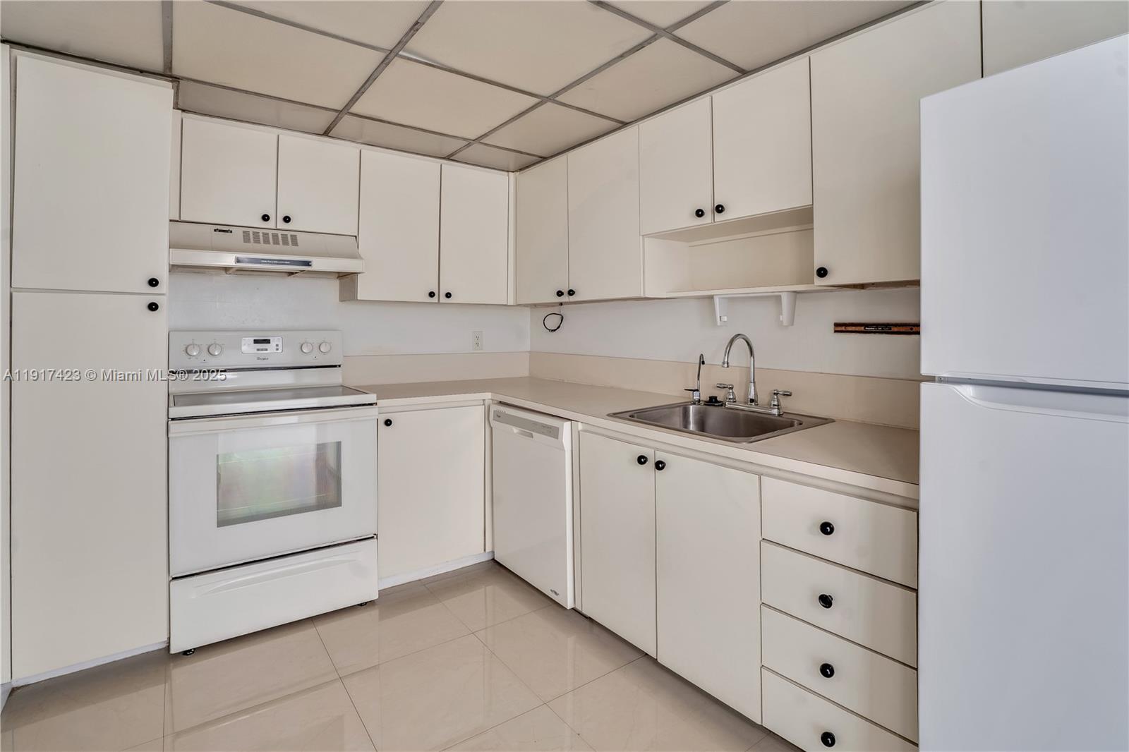 1200 St Charles Place, Unit 716 Pembroke Pines, FL 33026 - Photo 10 of 29 a kitchen with cabinets stainless steel appliances and sink