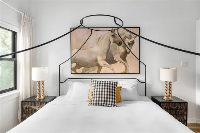 a view of a hallway with wooden floor and a floor to ceiling window