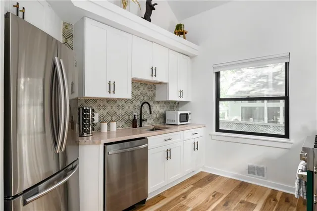 a bathroom with a sink vanity mirror and toilet