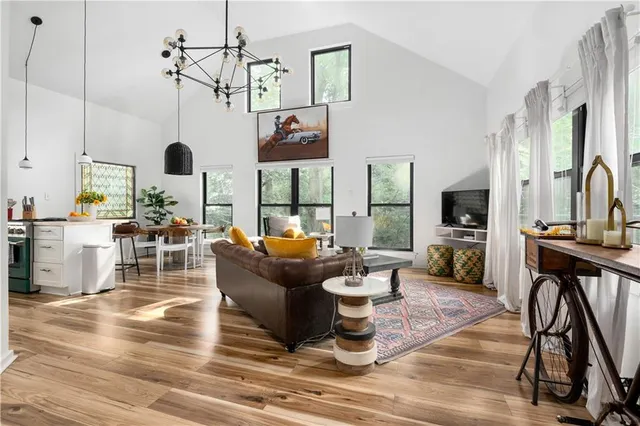 a living room with furniture and painting on the wall
