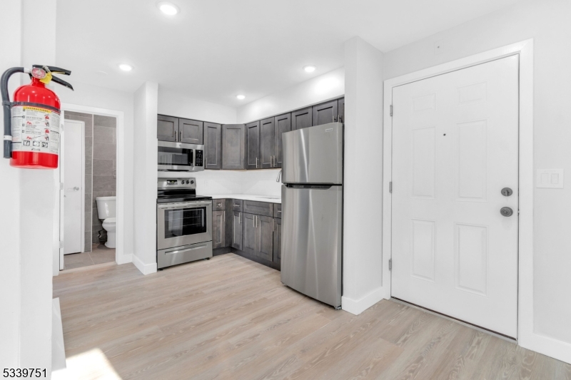 557 South Broad Street, Unit C2 Elizabeth, NJ 07202 - Photo 2 of 9 a kitchen with stainless steel appliances a refrigerator and a stove top oven