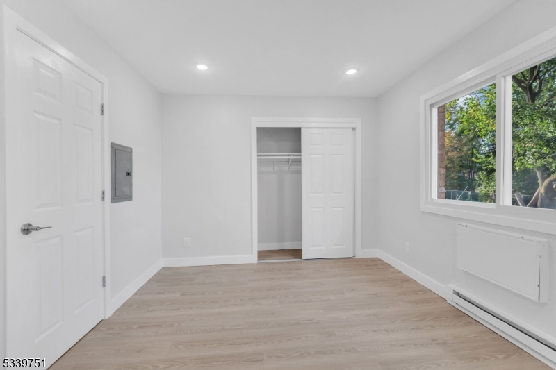 557 South Broad Street, Unit C2 Elizabeth, NJ 07202 - Photo 5 of 9 wooden floor in an empty room with a window