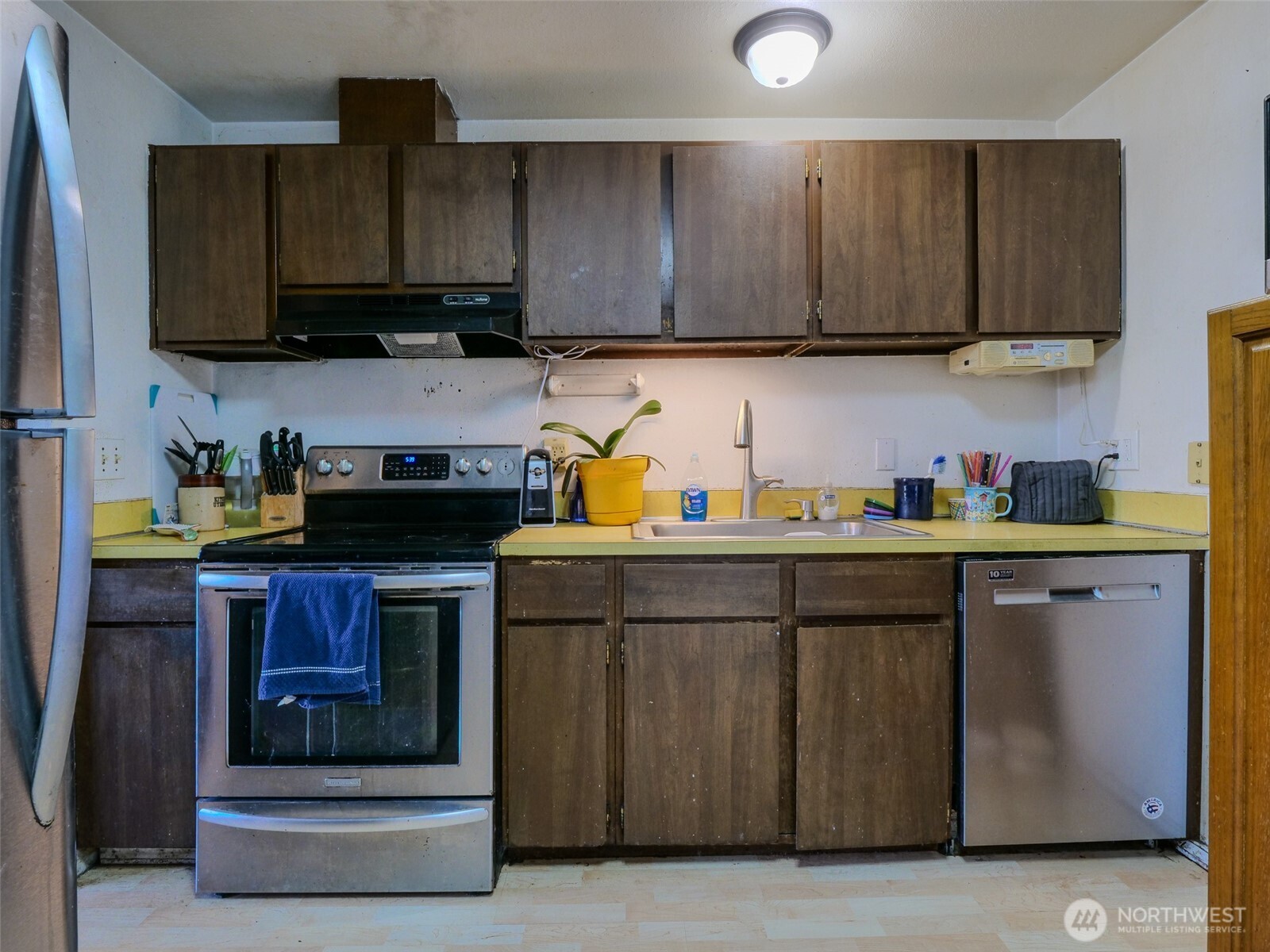 22502 3rd Place West Bothell, WA 98021 - Photo 6 of 10 a kitchen with stainless steel appliances granite countertop wooden cabinets and a stove top oven