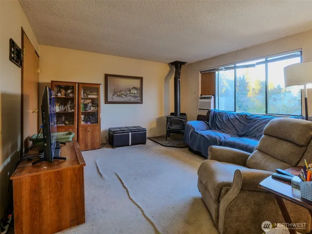 a living room with furniture a flat screen tv and a window