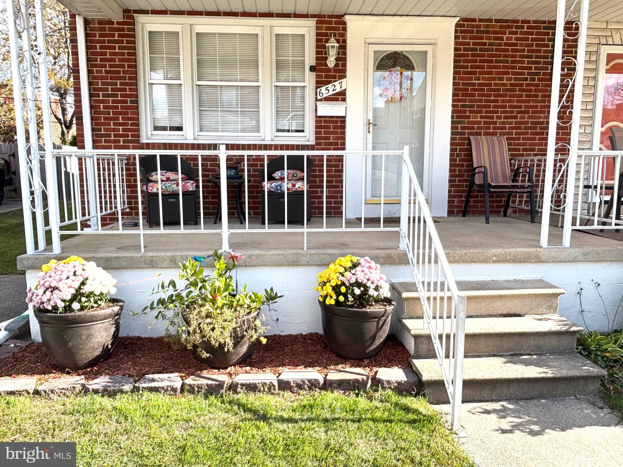 a front view of a house with outdoor seating