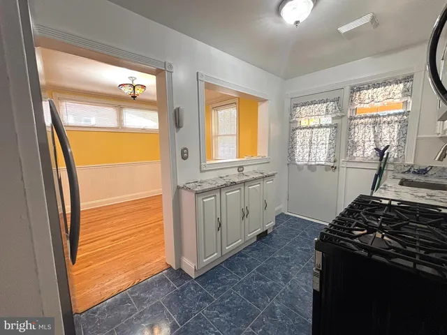a kitchen with a stove and a wooden cabinets