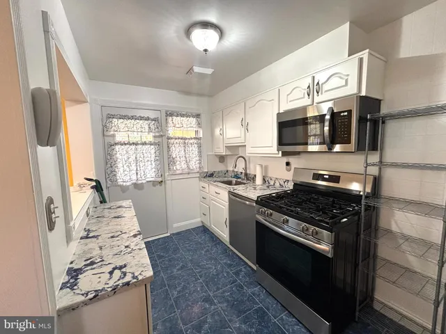 a kitchen with a stove and a microwave