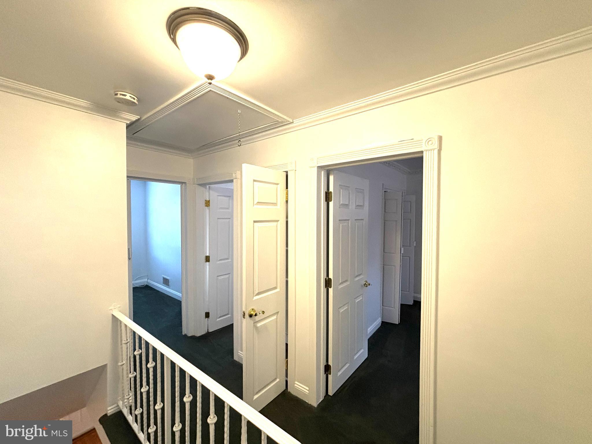6527 Hilltop Avenue Baltimore, MD 21206 - Photo 21 of 32 a view of a hallway with wooden floor and staircase