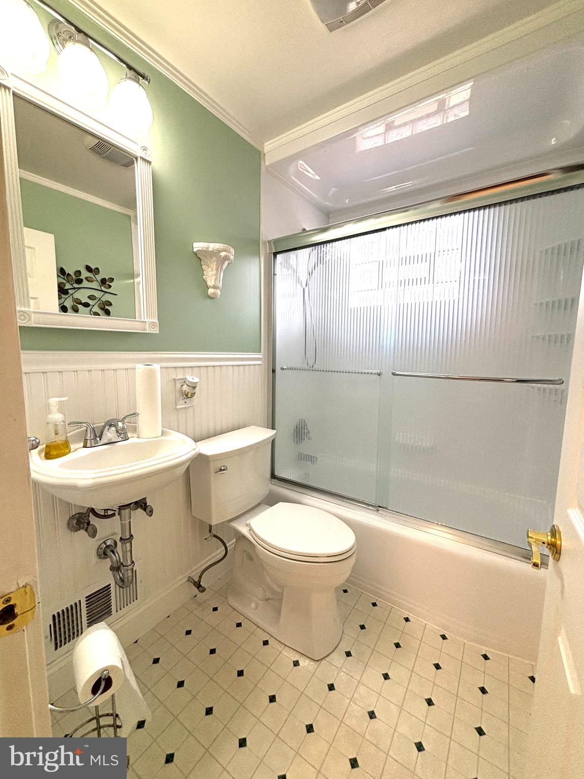 6527 Hilltop Avenue Baltimore, MD 21206 - Photo 24 of 32 a bathroom with a sink toilet a mirror and shower