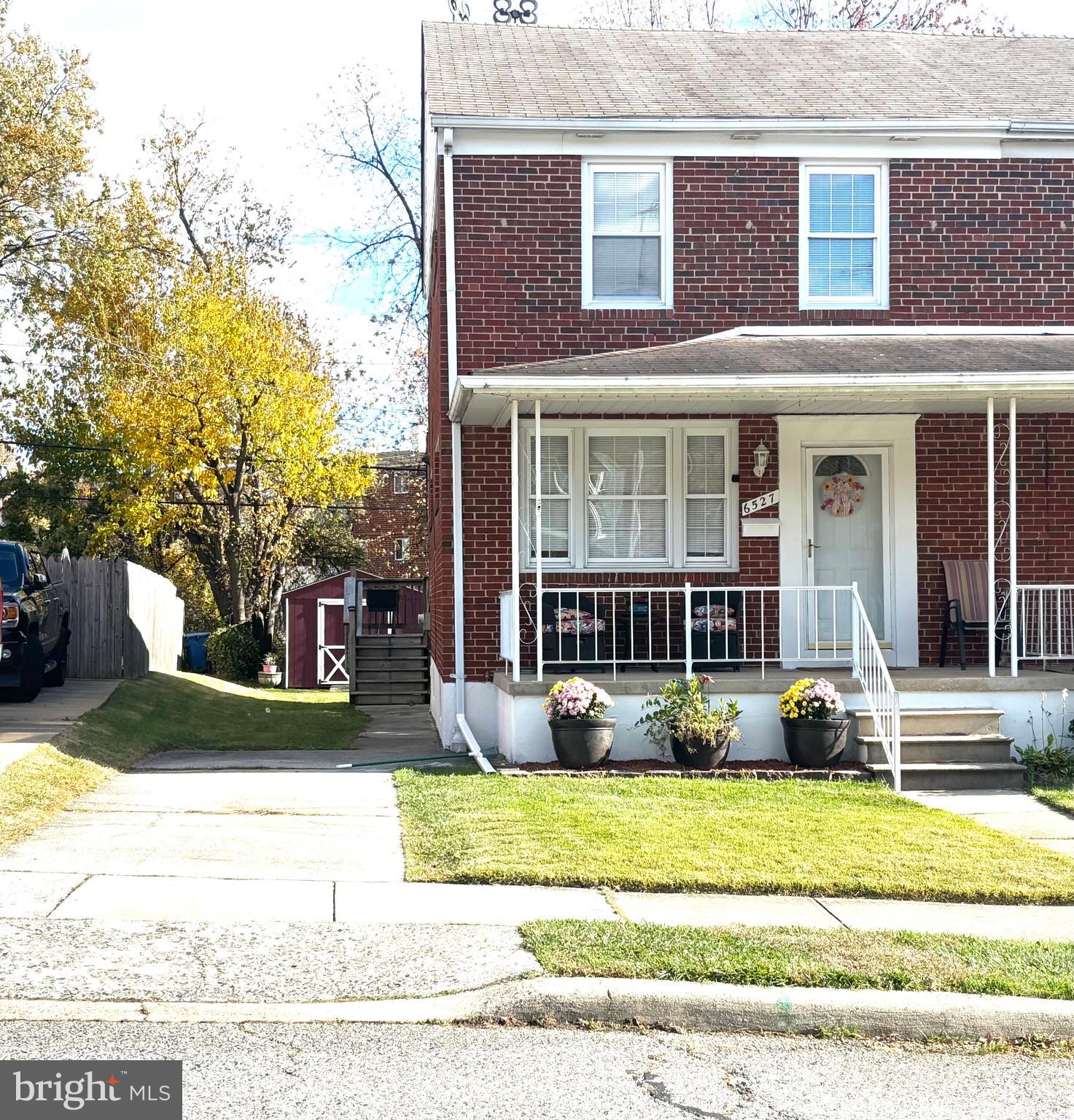 6527 Hilltop Avenue Baltimore, MD 21206 - Photo 5 of 32 a view of a brick house with many windows and plants