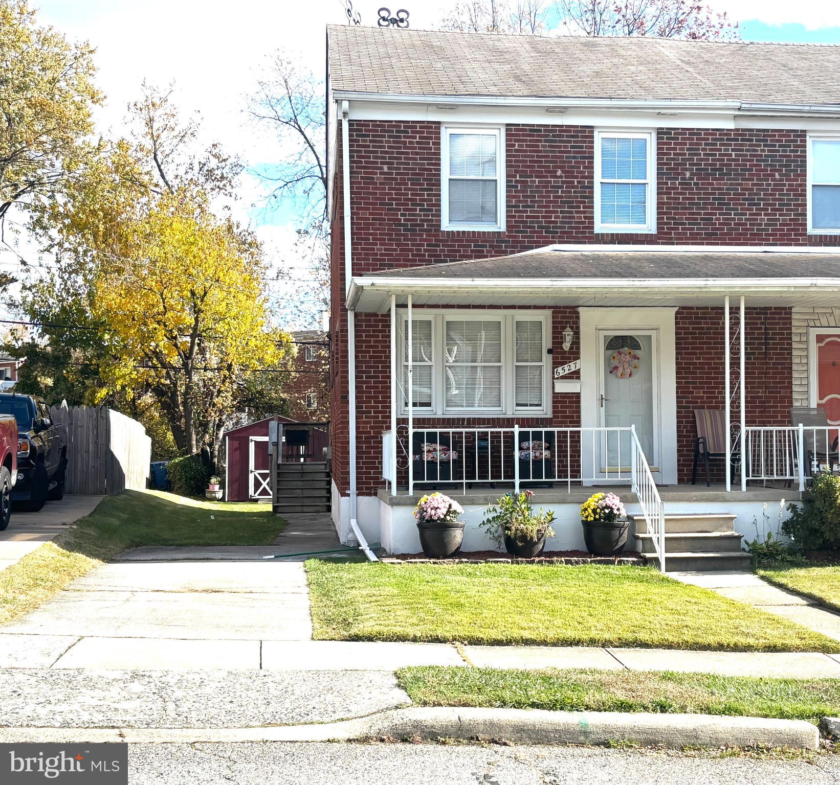 6527 Hilltop Avenue Baltimore, MD 21206 - Photo 7 of 32 a view of a brick house with many windows and plants