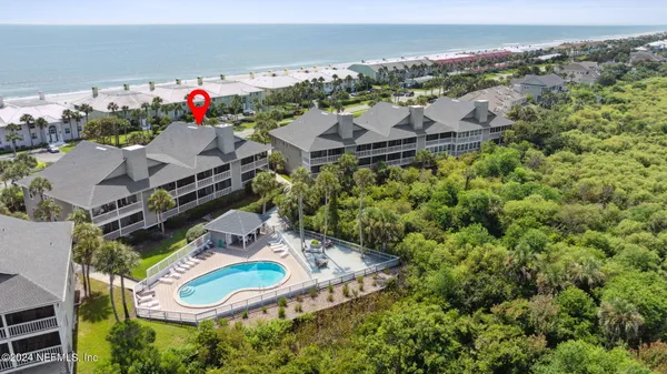 an aerial view of a house with a swimming pool