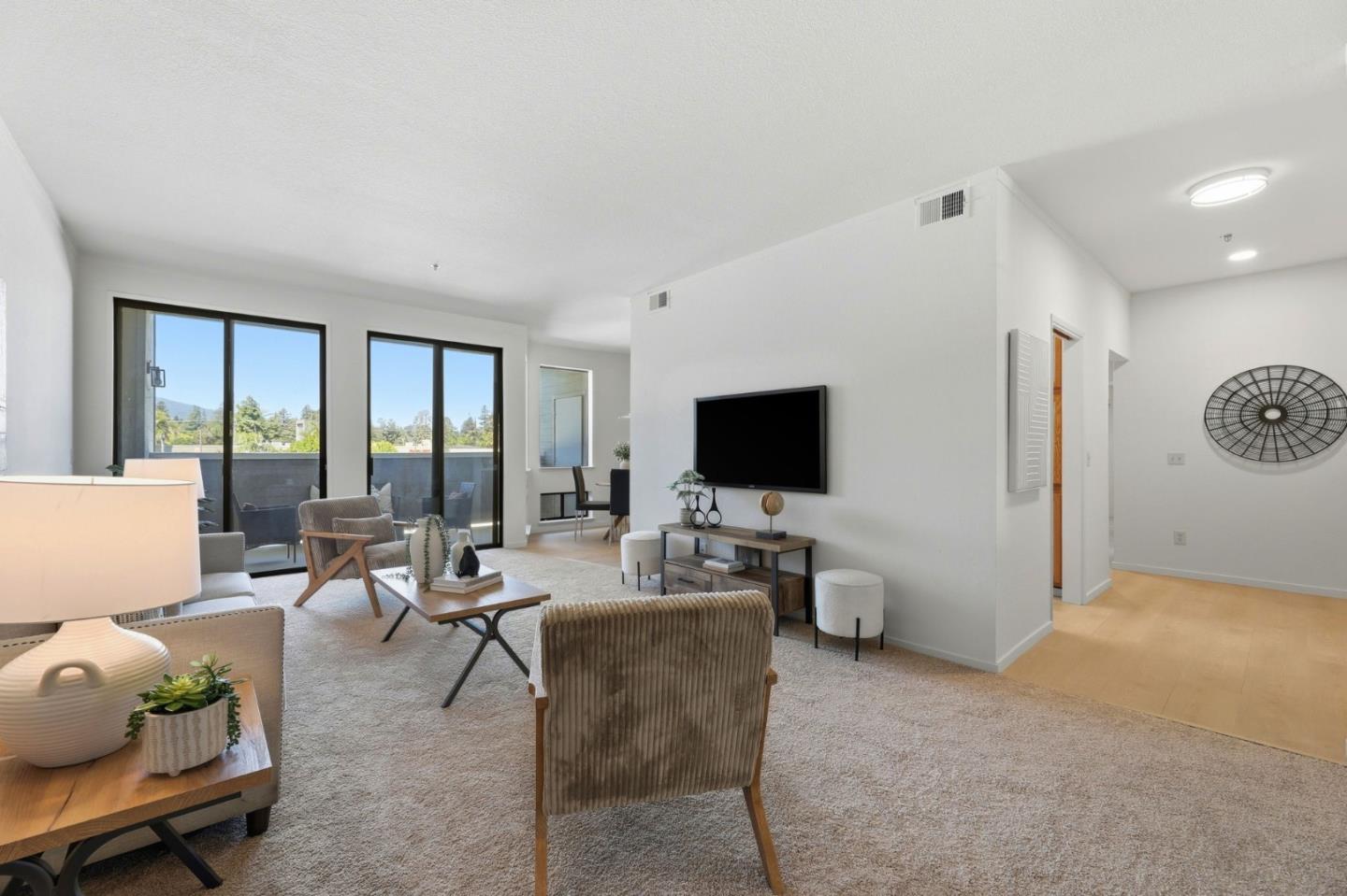 22330 Homestead Road, Unit 226 Cupertino, CA 95014 - Photo 10 of 38 a living room with furniture and a flat screen tv