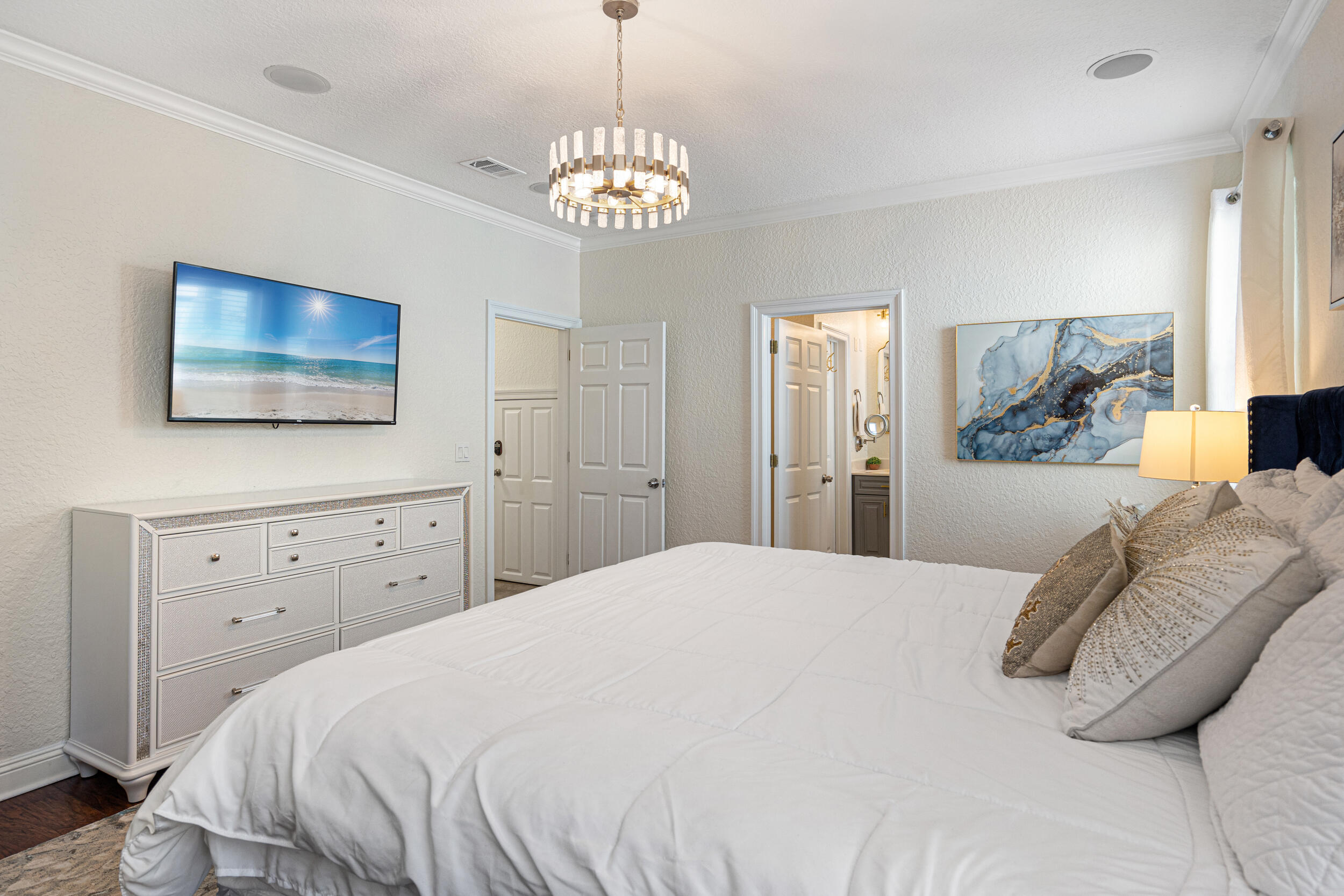 230 Kono Way Destin, FL 32541 - Photo 13 of 41 a bedroom with a bed and a chandelier