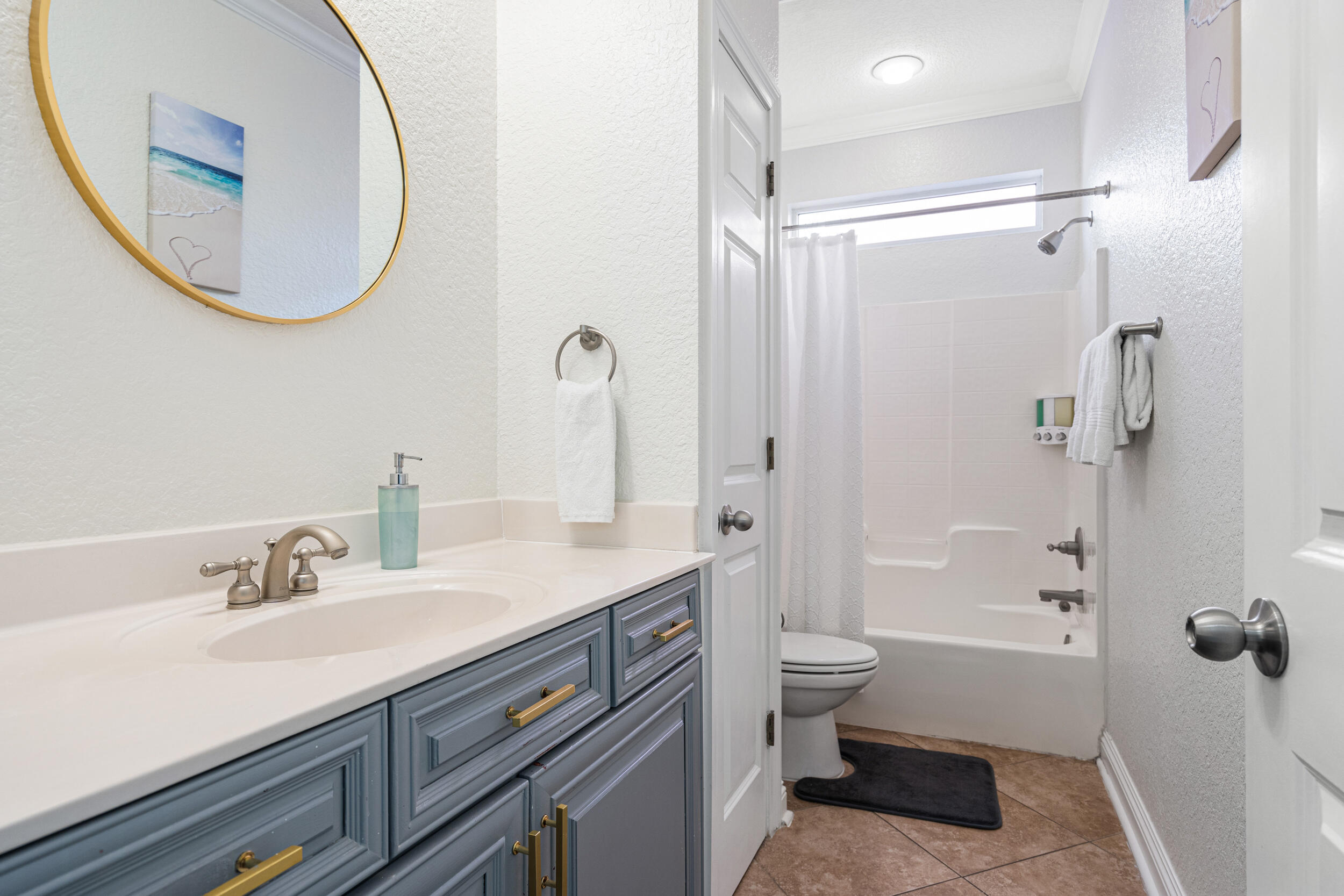 230 Kono Way Destin, FL 32541 - Photo 23 of 41 a bathroom with a sink a toilet and a mirror