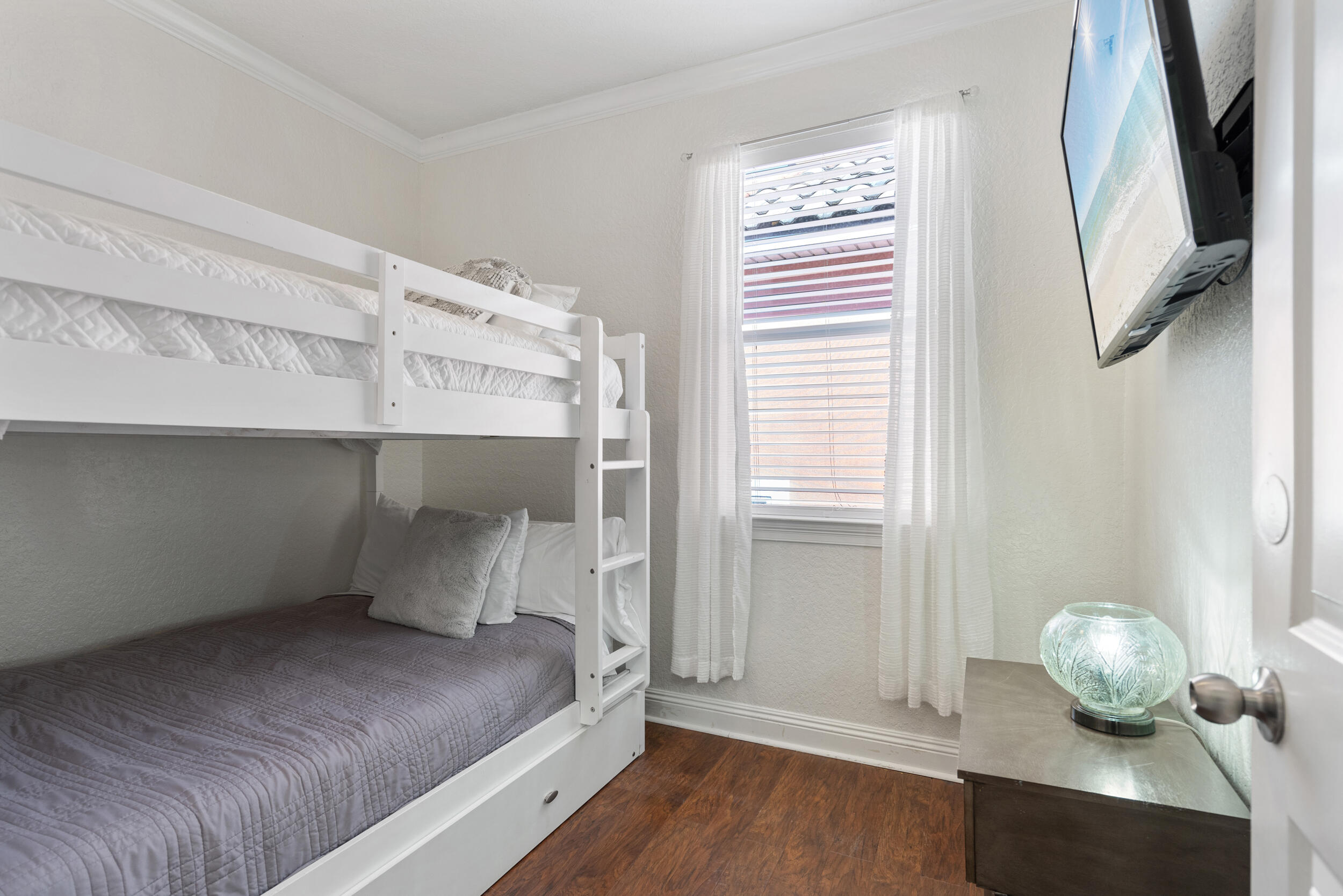230 Kono Way Destin, FL 32541 - Photo 30 of 41 a bedroom with a bed and wooden floor