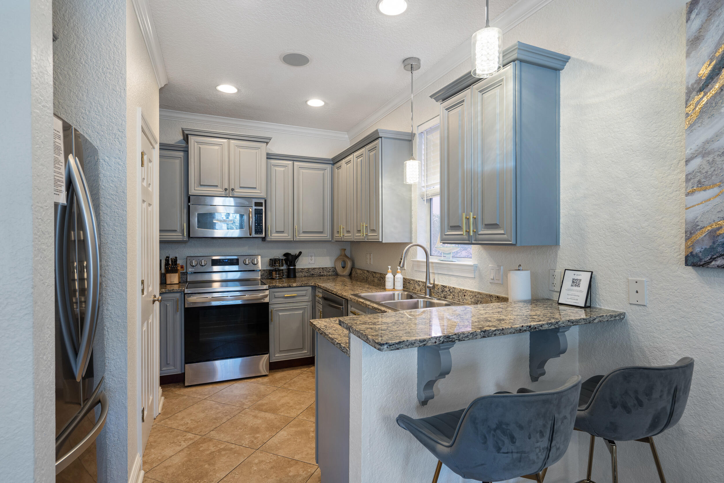 230 Kono Way Destin, FL 32541 - Photo 8 of 41 a kitchen with stainless steel appliances granite countertop a sink stove and refrigerator