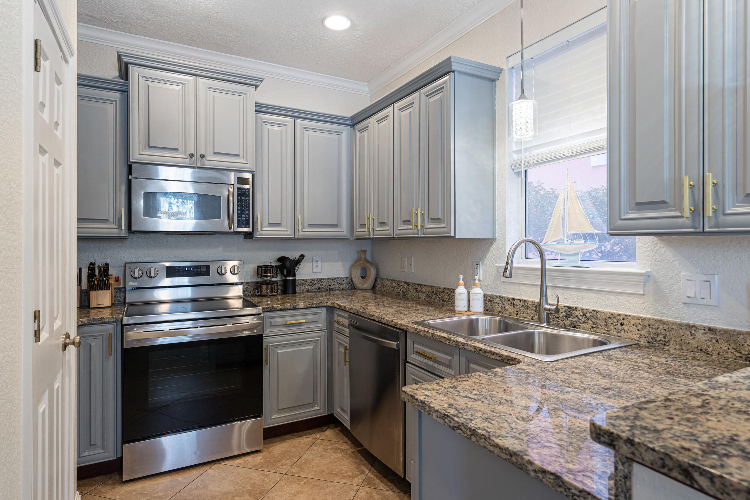 230 Kono Way Destin, FL 32541 - Photo 9 of 41 a kitchen with granite countertop a stove sink and cabinets